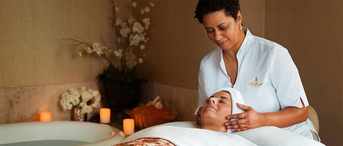 masseuse giving client a face massage